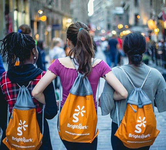 diverse students walking arm in arm