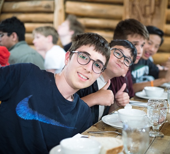 students happily eating at table