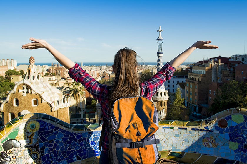 Girl with arms up overlooking Spanish city